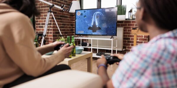 Wpływ gier wideo na narrację literacką 2 diverse-close-friends-in-living-room-sitting-on-so-2023-11-27-05-22-51-utc