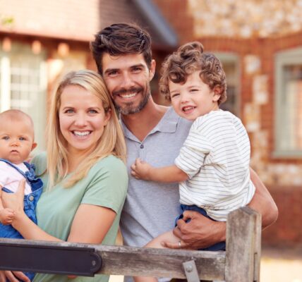 portrait of smiling family standing by gate outsid 2026 03 10 04 48 28 utc