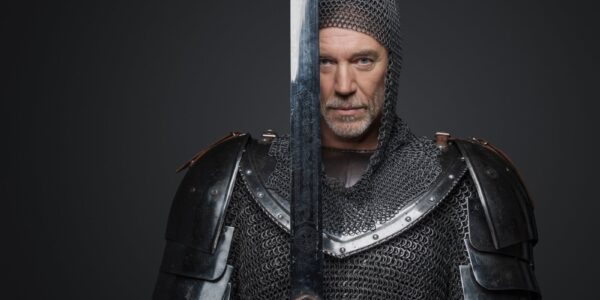 Dlaczego warto zaczynać Wiedźmina od opowiadań? O rytmie, bohaterach i wejściu do sagi 17 man in chainmail holding sword in studio 2026 09 23 03 25 12 utc